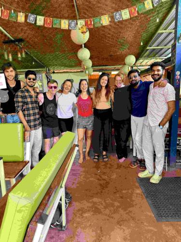 a group of people posing for a picture in a room at Happy Panda Hostel Arambol Goa in Arambol