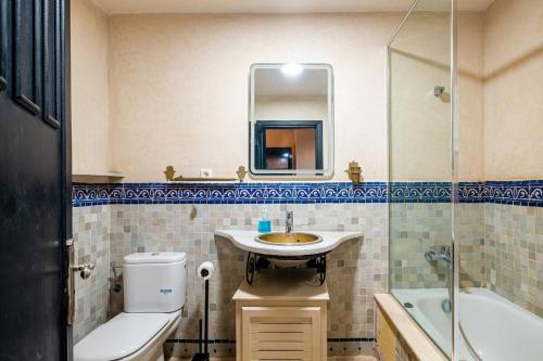 a bathroom with a sink and a toilet and a mirror at Atlas Golf Resort in Marrakesh