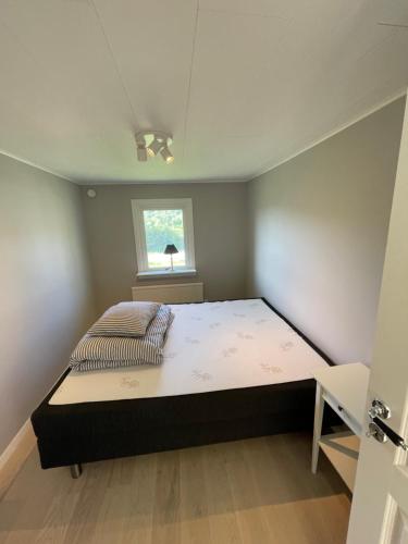 a bedroom with a large bed in a room at Ocean view Villa Säby Tjörn in Säby