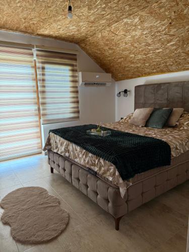 a bedroom with a large bed in a room at House Tickon Ostrog in Trubasinj