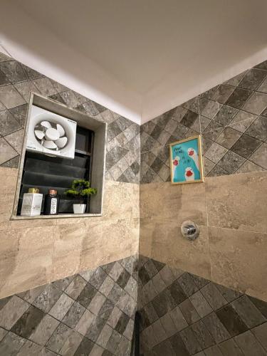 a bathroom with a shower with a tiled floor at Eden Stay in Siliguri