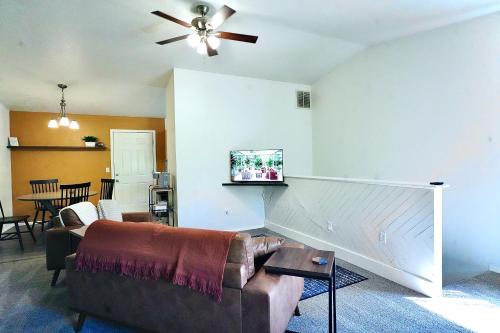 a living room with a couch and a ceiling fan at Pet-Family-Friendly Duplex with Parking in Wasilla
