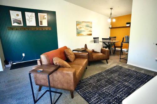 a living room with two couches and a table at Pet-Family-Friendly Duplex with Parking in Wasilla