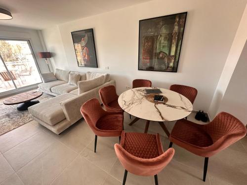 a living room with a table and chairs and a couch at Luxury La Cala de Mijas Sunset in Mijas Costa