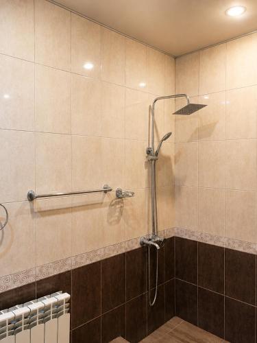 a shower with a glass door in a bathroom at Adams Rest House in Yeghegnadzor