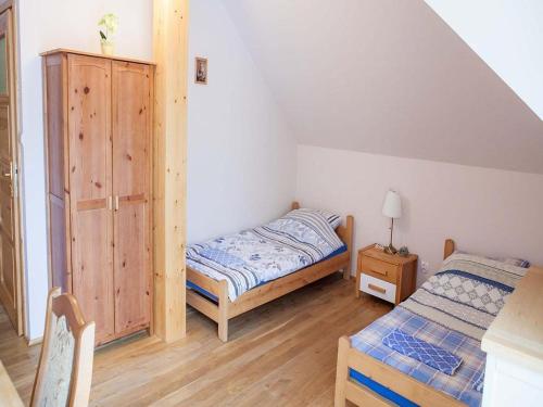 a small bedroom with a bed and a cabinet at 4-person room, sauna, Masuria in Ruciane-Nida