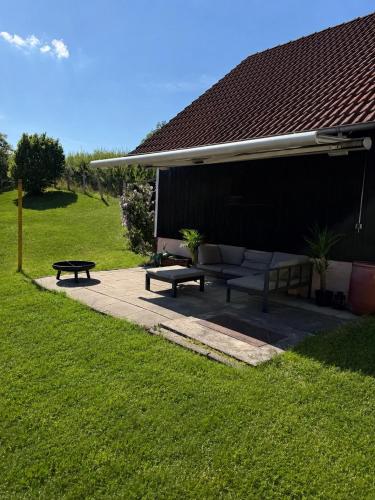 a picnic shelter with two benches in the grass at Danube Lodge in Hüfingen