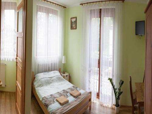 a bedroom with a bed in front of a window at Triple room, sauna, Masuria in Ruciane-Nida