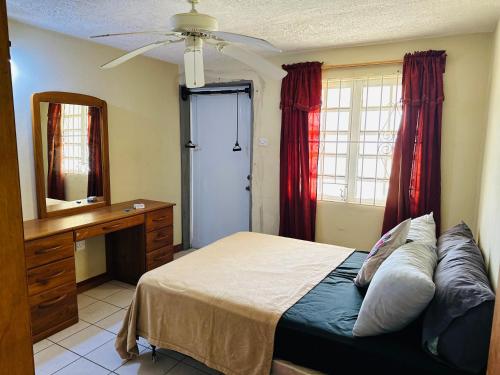 a bedroom with a bed and a dresser and a mirror at Guest house 2 in Upper Conaree