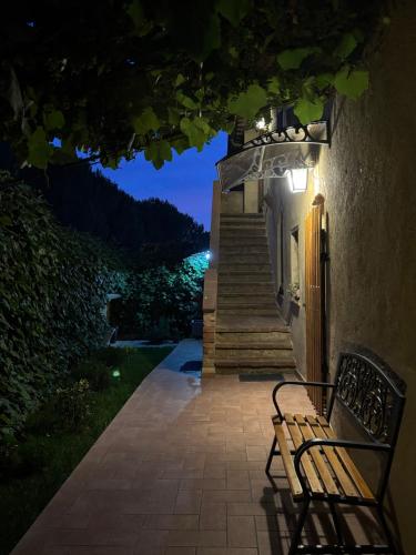 a bench sitting in front of a building with stairs at PAPAVERO ROSSO in San Gimignano