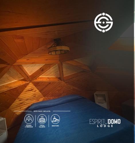 a room with a bed with a wooden ceiling at Espiritu Domo Lodge in Coinco