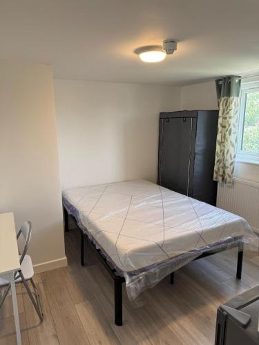a bedroom with a bed in the corner of a room at Private studio with a private bathroom and kitchenette in Edmonton