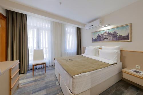 A bed or beds in a room at Nishant Hotel