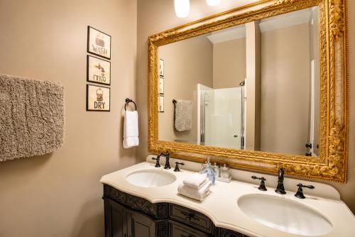 a bathroom with a sink and a mirror at Historic Main St Apt | Private Garage in St. Charles