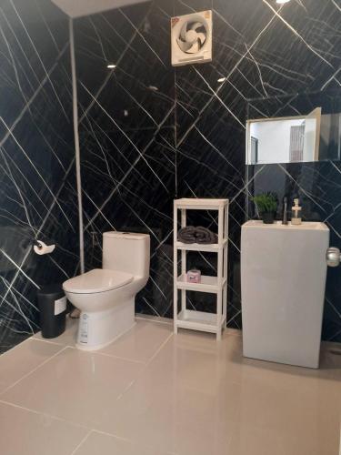 a bathroom with a toilet and a sink at Hidden courtyard in Ban Bang Phun
