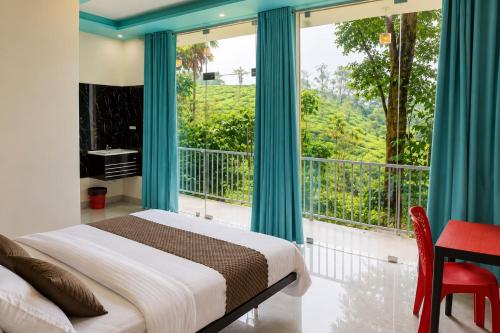 a bedroom with a bed and a large window at T Hill Vythiri Pool Resort in Vythiri