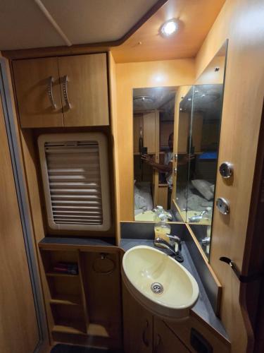 a bathroom with a sink and a mirror in an rv at Sterling Leisure in Ferryhill