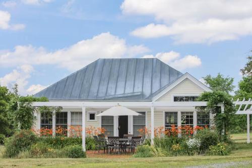 a white house with a gray roof at Whitford House Cottage in Addison