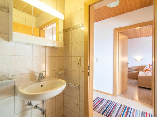 a bathroom with a sink and a mirror at Haus Sporer in Gerlosberg