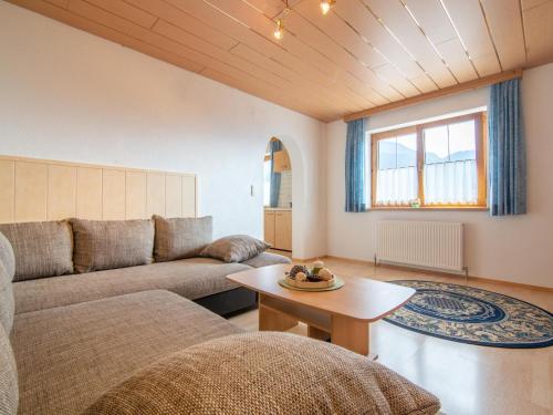 a living room with a couch and a table at Haus Sporer in Gerlosberg