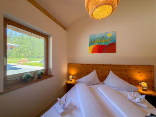 a bedroom with a large bed and a window at Warös 59 in Lake Pressegg