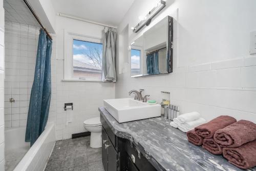 a white bathroom with a sink and a toilet at Finch Terminal Station 1min -Yonge and Finch Intersection in Toronto