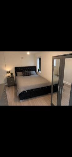 a bedroom with a large bed and a mirror at Hunters lodge in Blackpool