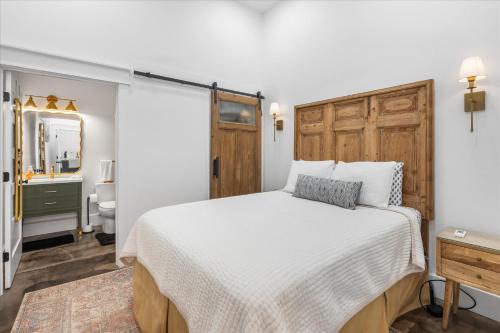 a bedroom with a large bed and a bathroom at Downtown Mobile Pets Ok Walkable Secure Parking in Mobile