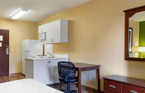 a small kitchen with a desk and a chair at Extended Stay America Suites - Savannah - Midtown in Savannah