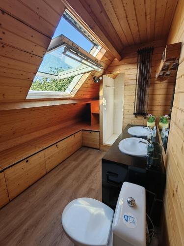 a bathroom with two sinks and a window at Maison de charme 209m2 in Coray