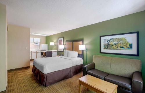 a hotel room with a bed and a couch at Extended Stay America Select Suites - Atlanta - Perimeter - Hammond Drive in Atlanta