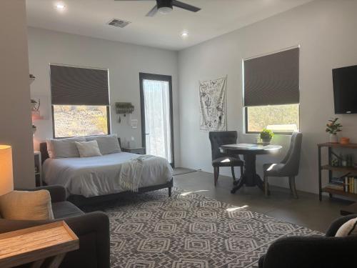 a bedroom with a bed and a table and chairs at Lazy G Ranch Casita 