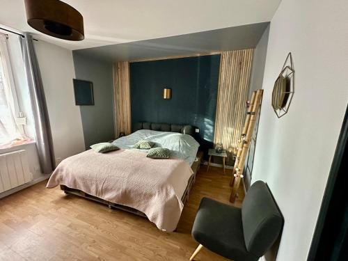a bedroom with a bed and a chair in it at Cocon entre centre ville autoroute in Reims