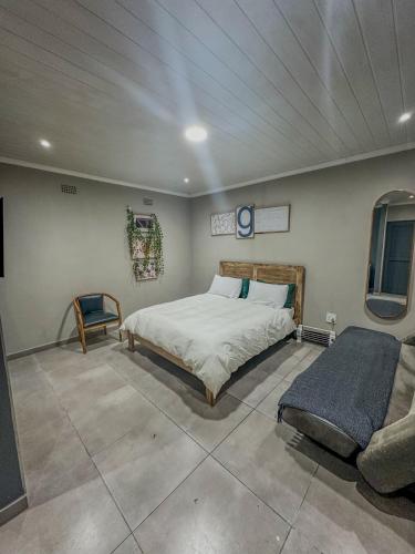 a bedroom with a bed and a couch in it at Blade Flatlet 2 in Silver Sands