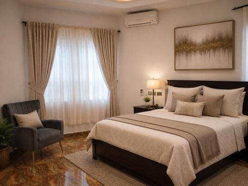 a bedroom with a large bed and a chair at Fairview Executive Suites in Bawalishi