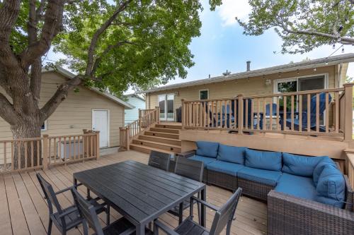 a deck with a couch and a table and chairs at CozyLiving in Billings