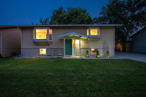 a house with a green door and a yard at CozyLiving in Billings