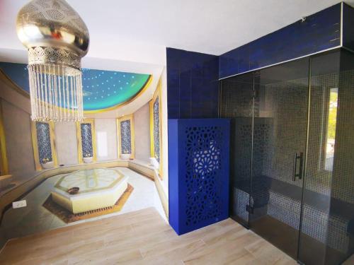 a large bathroom with a shower and a chandelier at B&B Hidden gem Blagaj in Blagaj