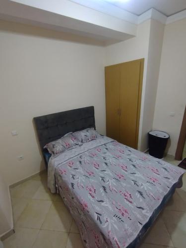 a bedroom with a large bed with a bedspread at Comp al Farah in Tangier