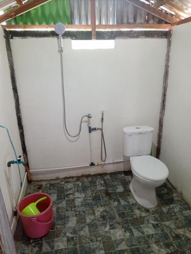 a bathroom with a toilet and a shower at Jufri Homestay in Kasijala