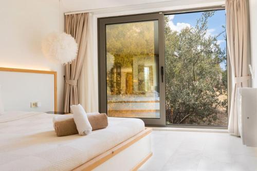 a white bedroom with a large window and a bed at Villa Studio Deluxe Kalkan in Kaş
