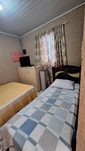 a bedroom with two beds and a laptop in it at Casa ideal in São Caetano do Sul