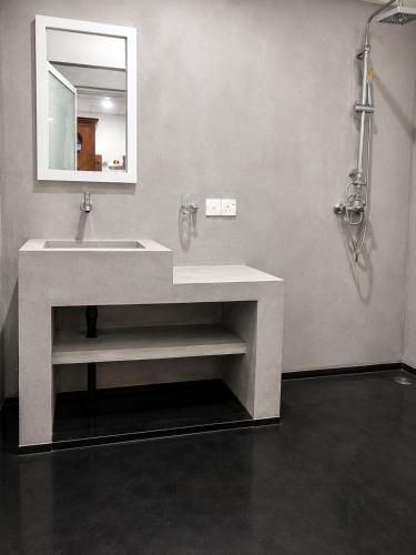 a bathroom with a sink and a mirror at Amore Beach Resort in Balapitiya