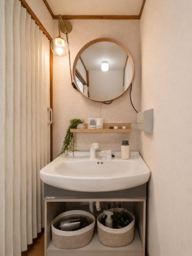 a bathroom with a sink and a mirror at Forest Agata in Matsumoto