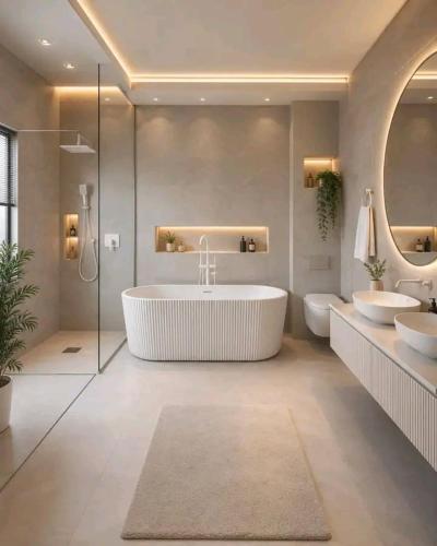 a bathroom with two sinks and a tub and two toilets at JKIA Prestige kenya in Nairobi