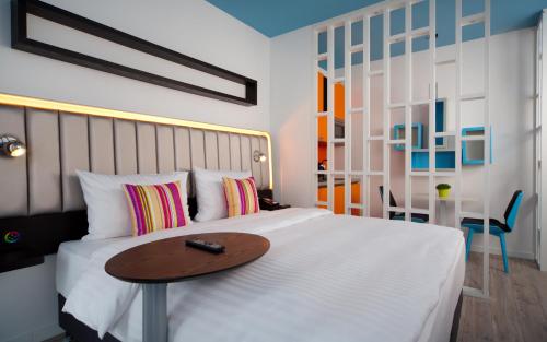 a bedroom with a bed with a wooden table on it at Park Inn by Radisson Residence Riga Barona in Rīga