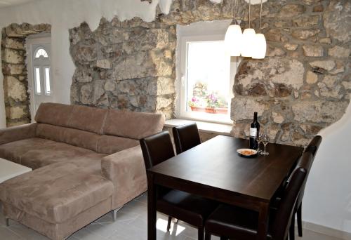 a living room with a couch and a table at Apartments Casa Nora in Lupoglav