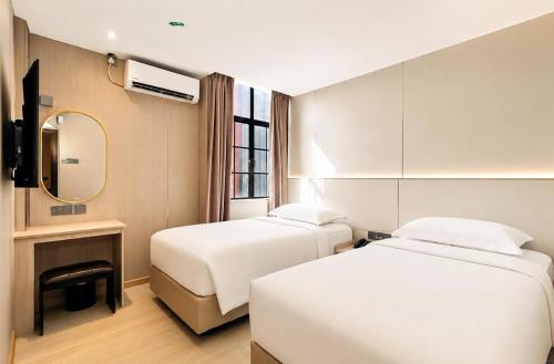Giường trong phòng chung tại Hotel Ming Star