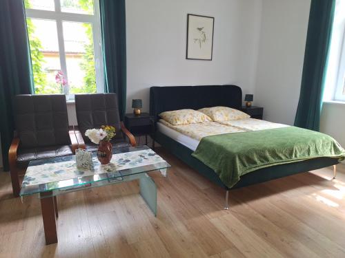 a bedroom with a bed and a coffee table at agroturystyka Drużno in Elblag