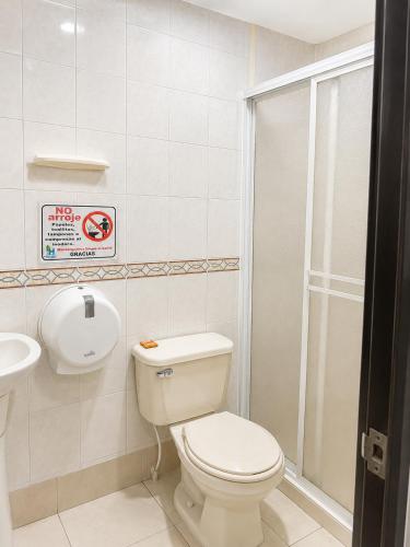 a bathroom with a toilet and a sink and a shower at Hotel Medellin in Santa Marta